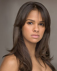 A young woman with long brown hair that is parted in the middle.