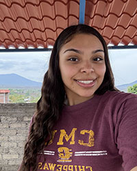 A head shot of a young woman with long hair and wearing a CMU sweatshirt.