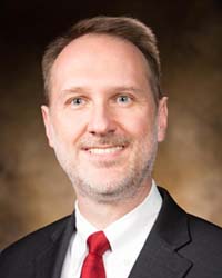 David Ford, Dean of the College of Science and Engineering, wears a jacket, tie and collared shirt for his headshot.