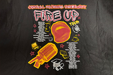 A concert-themed t-shirt design with the words Central Michigan University, Fire Up, Tour and images of a mouth and microphone.