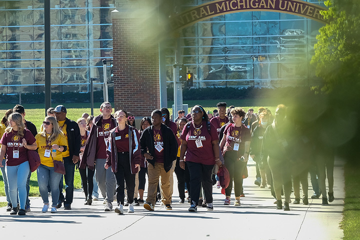 a group of people walking on a sidewalk