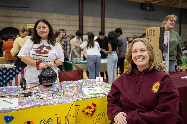 Two students smile for the camera during Spring MainStage inside the SAC.