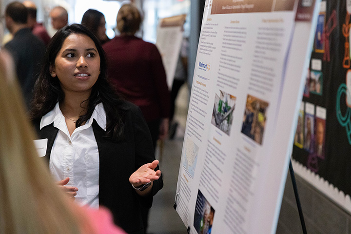 A woman looking at a poster