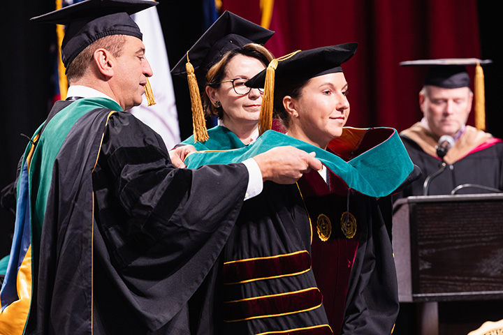 A group of people wearing graduation gowns