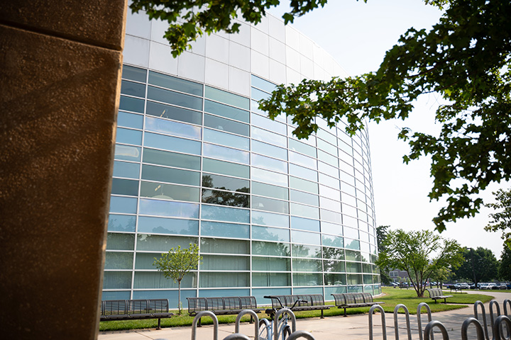 A building with a wall of windows and a bike rack