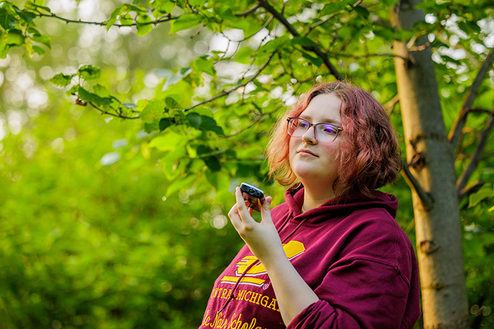 A woman holding a phone in her hand.