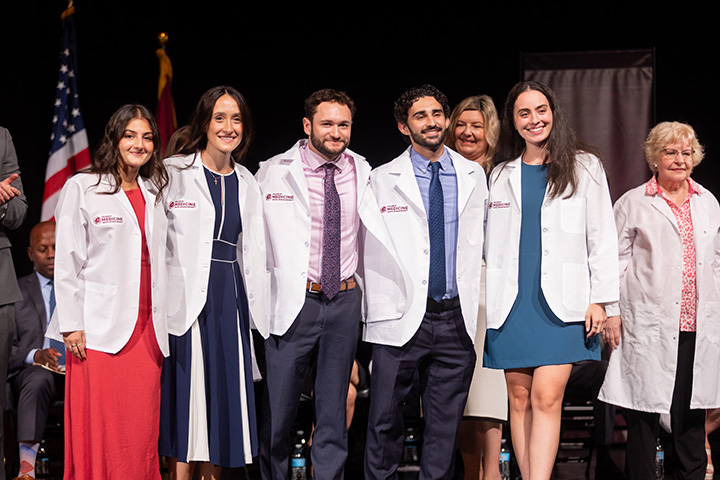 A group of medical students standing together on a stage