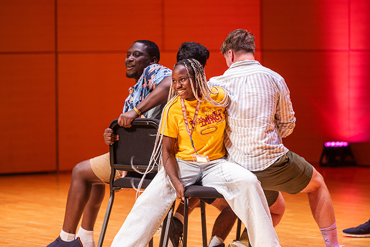 A group of people sitting on chairs on a stage