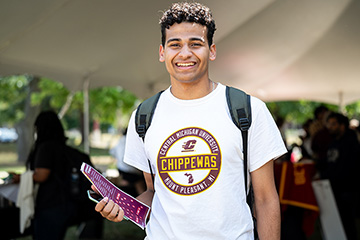 A man wearing a Central Michigan University t-shirt smiling at the camera