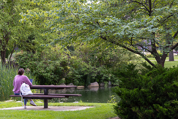 A woman sitting at a picnic table