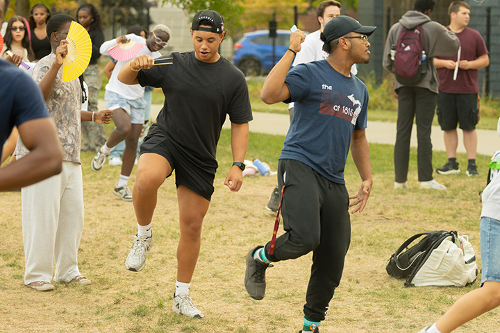 A group of people dancing in a field