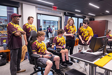 A group of people in a room playing video games