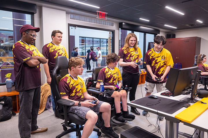 A group of people in a room playing video games