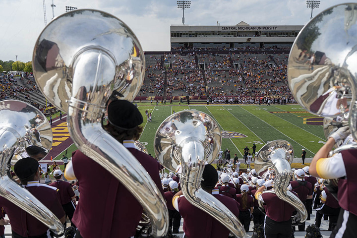 Agroup of people playing instruments in a football stadium