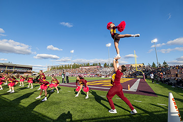 Cheerleaders performing on a football field