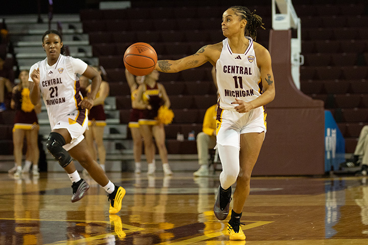 A CMU women's basketball player dribbles the ball down the court