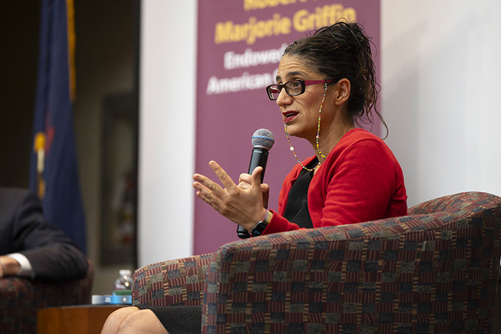 A woman sitting in a chair holding a microphone