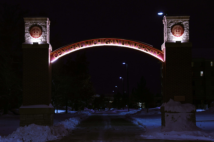 The CMU Voisin Arch is lit up at night.