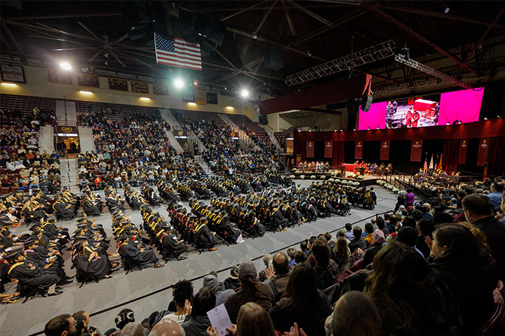 A group of people sitting in an arena.
