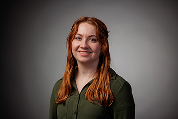 A woman with red hair smiling