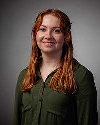 A woman with red hair smiling.