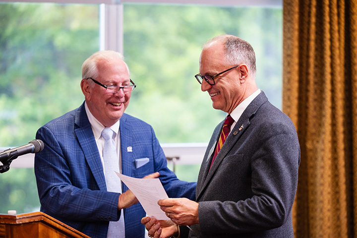 Edward Plawecki and Bradley Swanson smile during a CMU Board of Trustees meeting