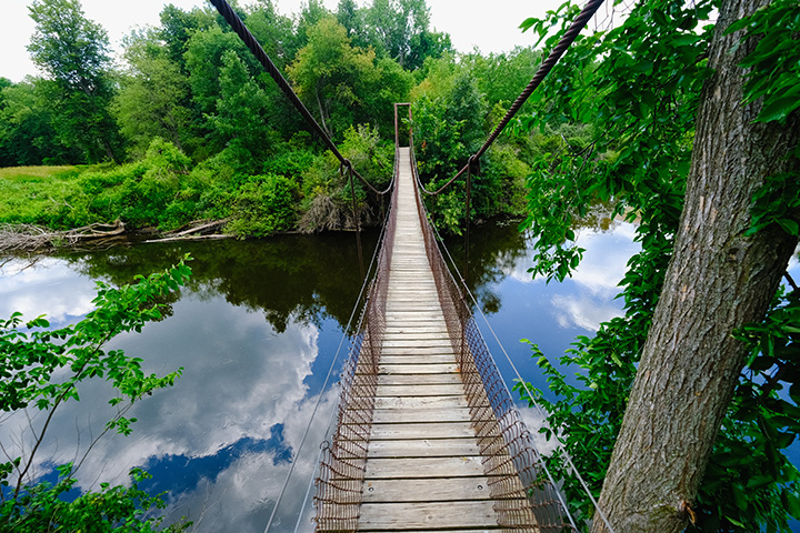 A rope bridge extends across the Chippewa River