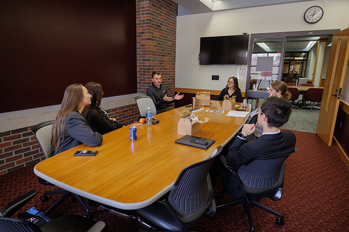 A group of people sitting around a long table in a conference room