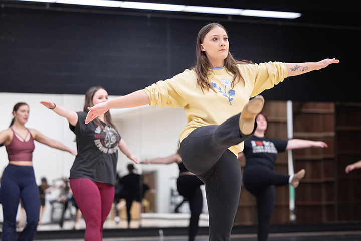 A group of students dancing in a classroom.