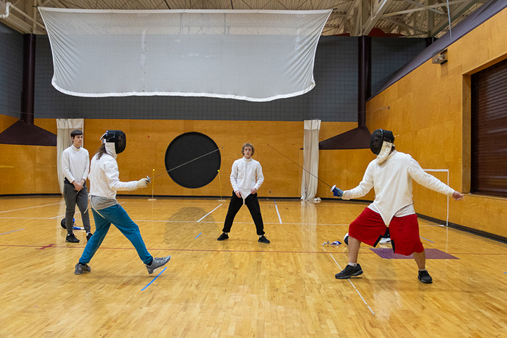 A group of people in fencing gear.