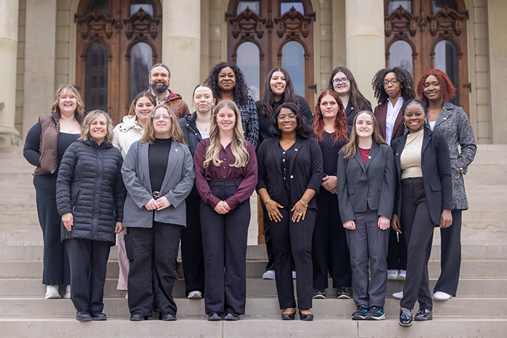 A group of 16 public health students and faculty on the steps of the Michigan Capitol Building.