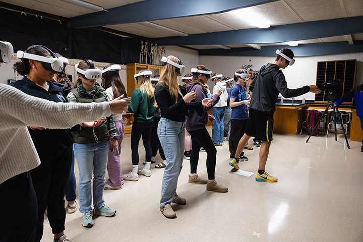 A group of high school students wearing Meta Quest headsets in a classroom
