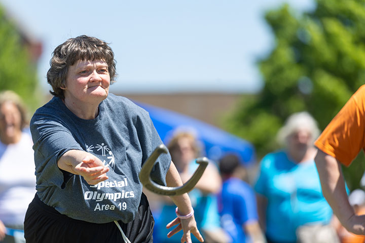 A female Special Olympics athlete competes in horseshoes