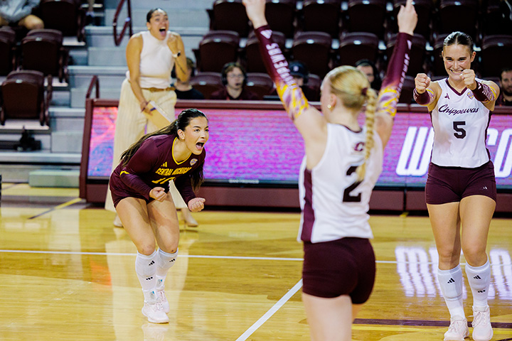 CMU volleyball players celebrate a point