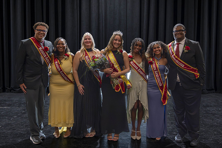 The Maroon and Gold Ambassadors pose for a group photo in an auditorium