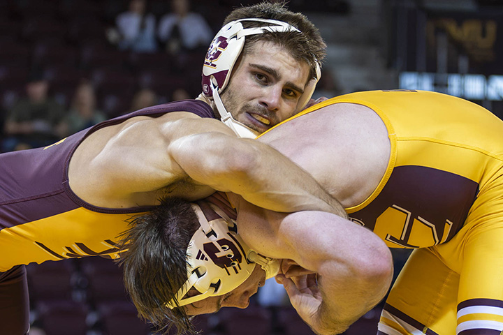 Two CMU wrestlers grapple during a match
