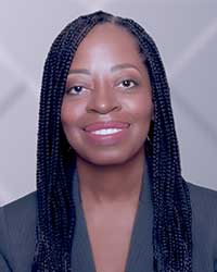 A professional headshot photo of a Black woman with long dark hair
