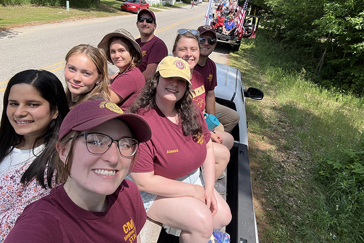 A selfie of CMU students and staff in the back of a truck