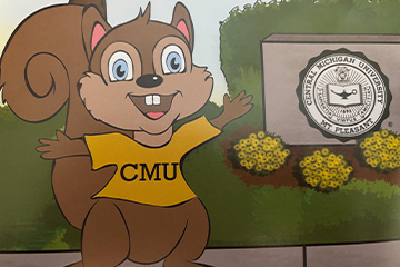 Illustrated Squirrel wearing a CMU shirt standing next to a CMU sign and flowers.