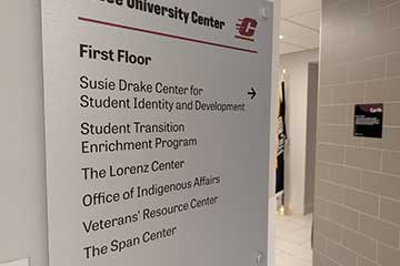 A light silver directional sign features the names of several CMU offices