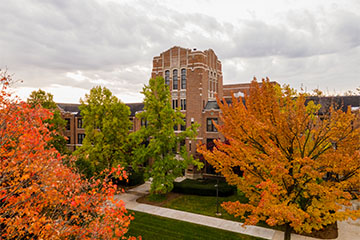 The sun breaks through the clouds on a fall day in Warriner Mall at Central Michigan University.