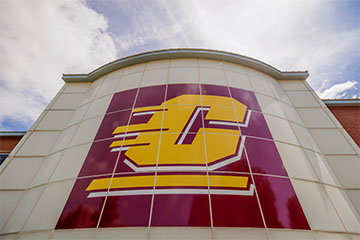 Large CMU "action C" logo on the side of a campus building.