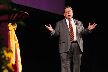 CMU President Bob Davies on stage giving the 2023 State of the University Address.