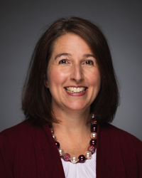 A close-up of a woman smiling