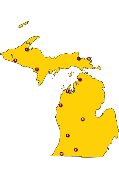 Outline of Michigan with numbers at specific locations in maroon and white showing the state's 12 tribal areas.
