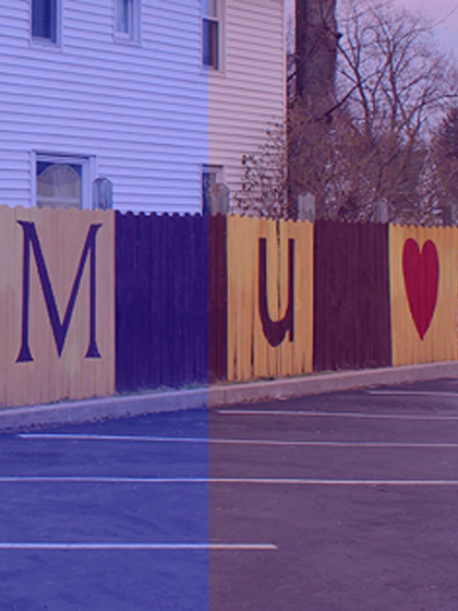 CMU painted on fence
