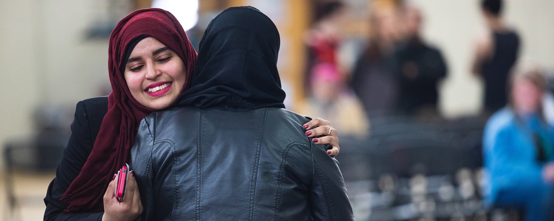 Students embrace at the International Student Expo