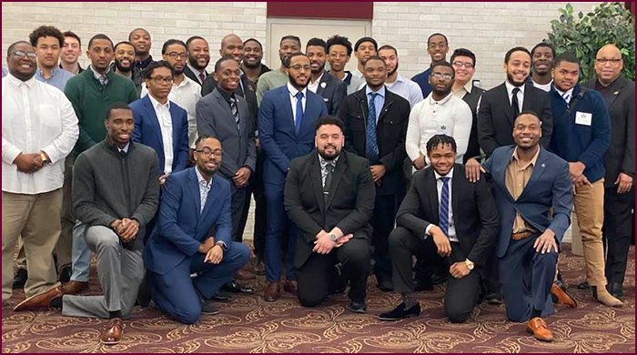 Participants in Men About Change wear formal attire and pose for a group photo