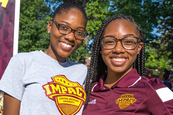 Two female volunteers at IMPACT event