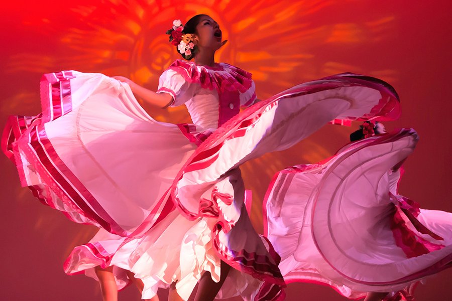 Female dancer in large, vibrant and flowing red dress